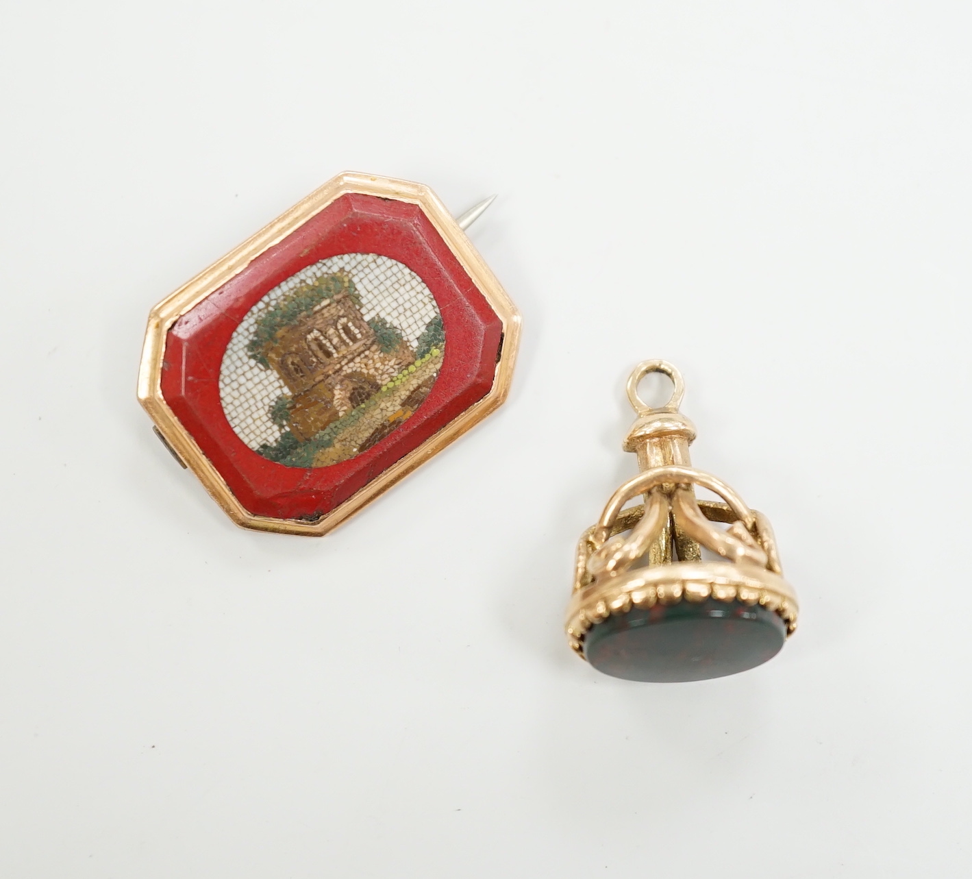 A 19th century yellow metal and micro mosaic set brooch, 23mm and a similar yellow metal overlaid and bloodstone set fob seal.